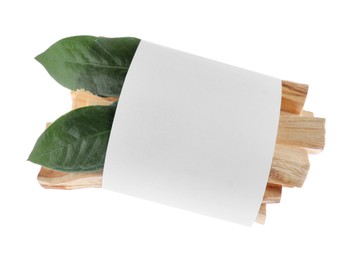 Photo of Palo santo sticks wrapped in paper and green leaves on white background