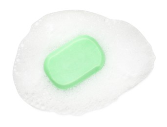 Photo of Green soap with foam on white background, top view