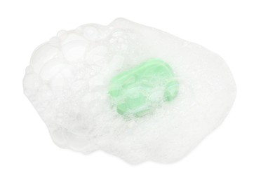 Photo of Green soap with foam on white background, top view