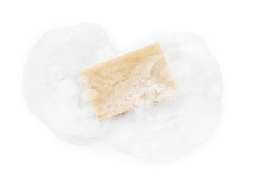 Photo of Beige soap with foam on white background, top view