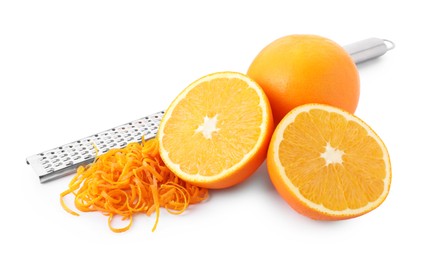 Photo of Pile of fresh orange zest, fruits and grater isolated on white