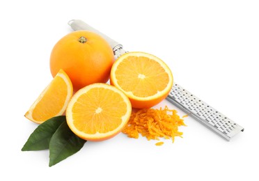 Photo of Pile of fresh orange zest, fruits, grater and leaves isolated on white