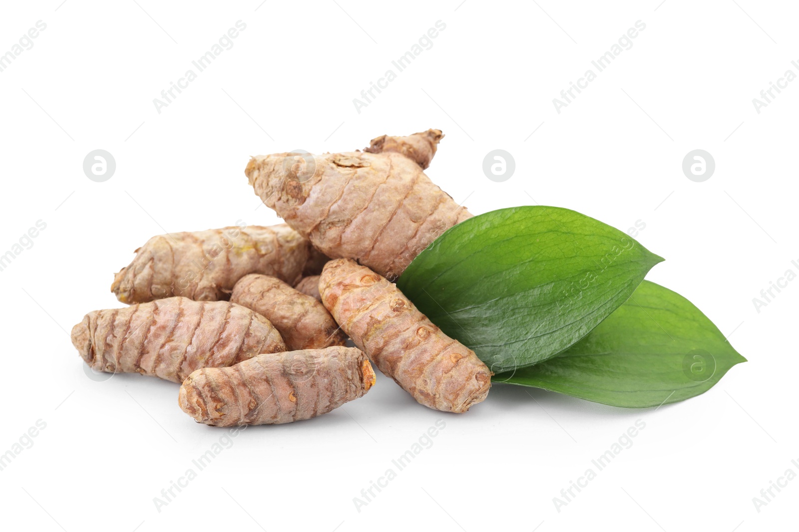 Photo of Raw turmeric roots and green leaves isolated on white