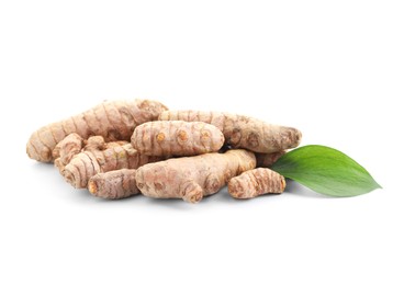 Photo of Raw turmeric roots and green leaf isolated on white