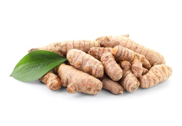 Photo of Raw turmeric roots and green leaf isolated on white