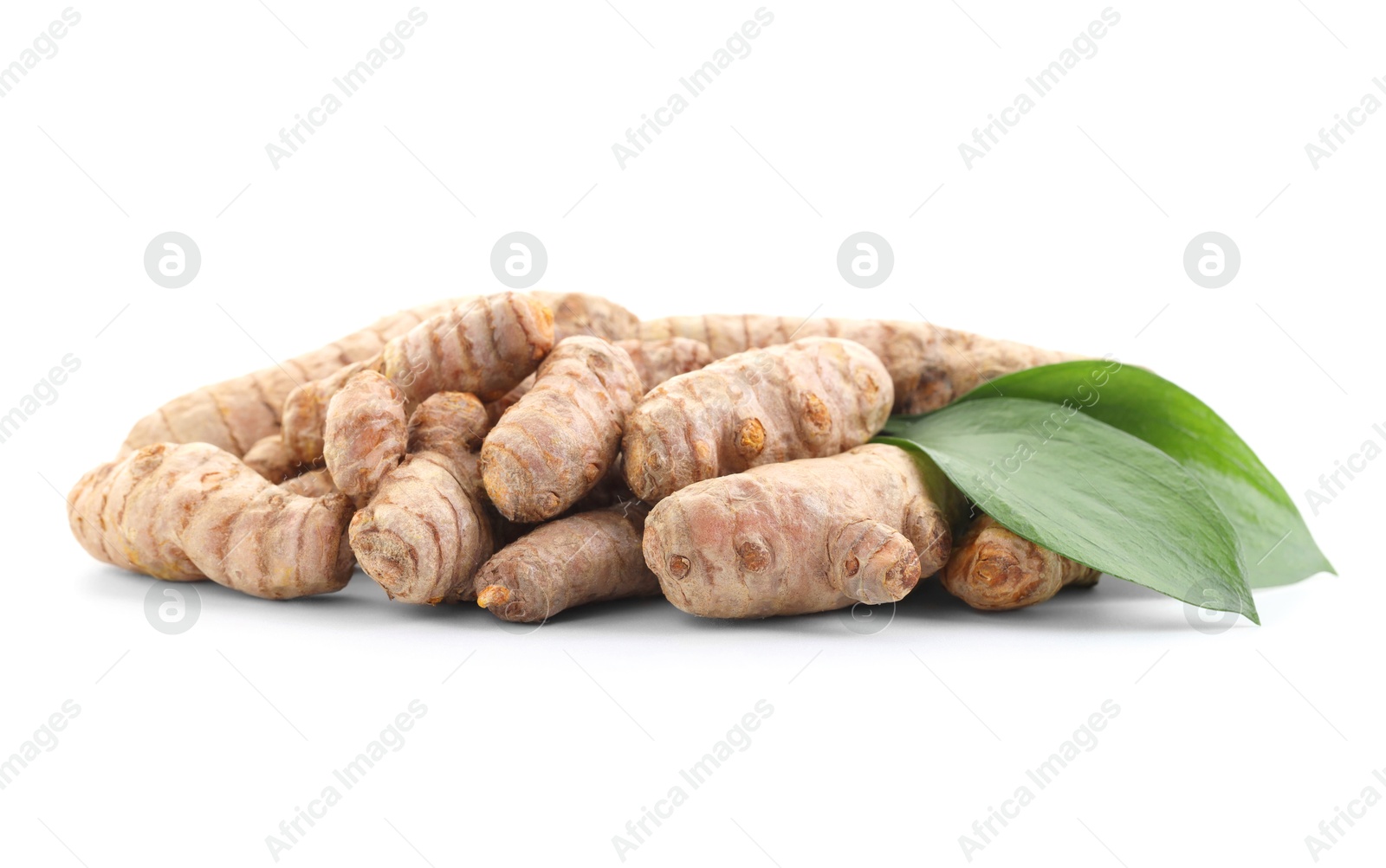 Photo of Raw turmeric roots and green leaves isolated on white