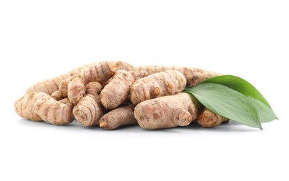 Photo of Raw turmeric roots and green leaves isolated on white