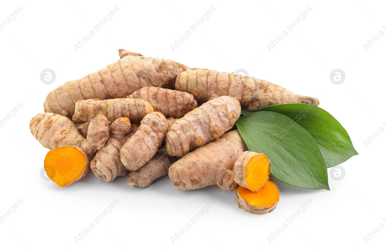 Photo of Raw turmeric roots and green leaves isolated on white