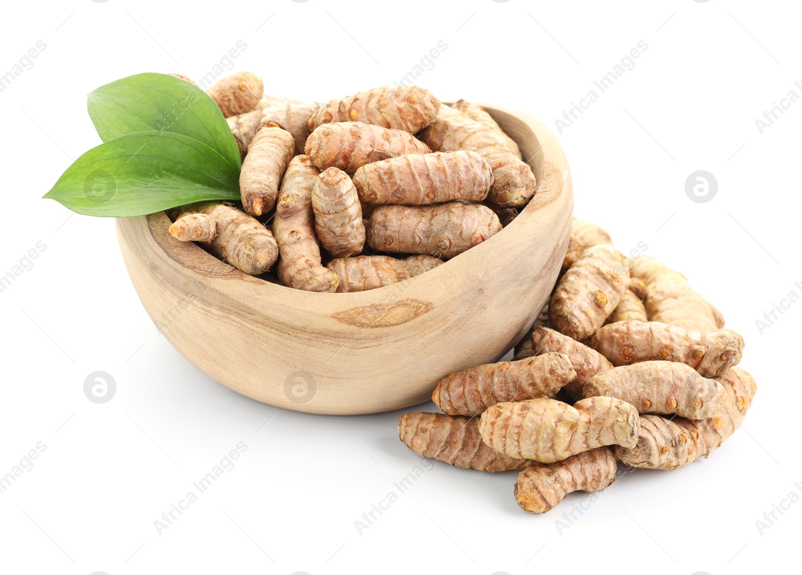 Photo of Raw turmeric roots and green leaves isolated on white