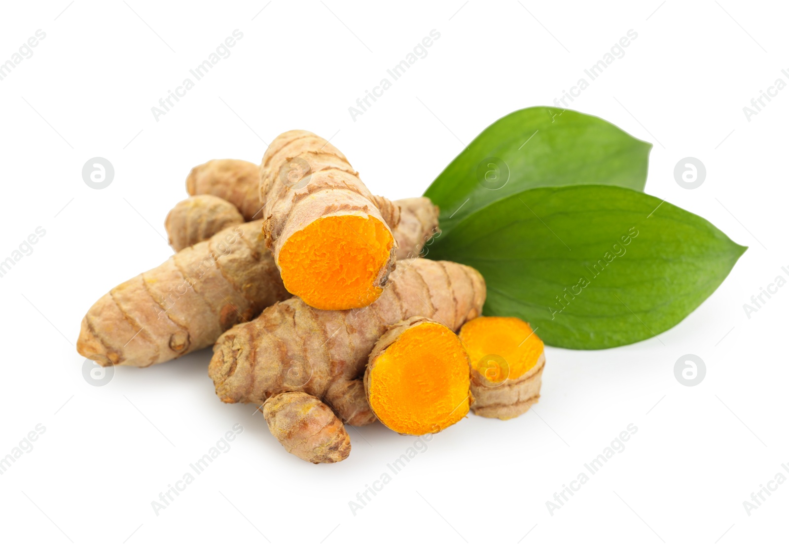 Photo of Raw turmeric roots and green leaves isolated on white