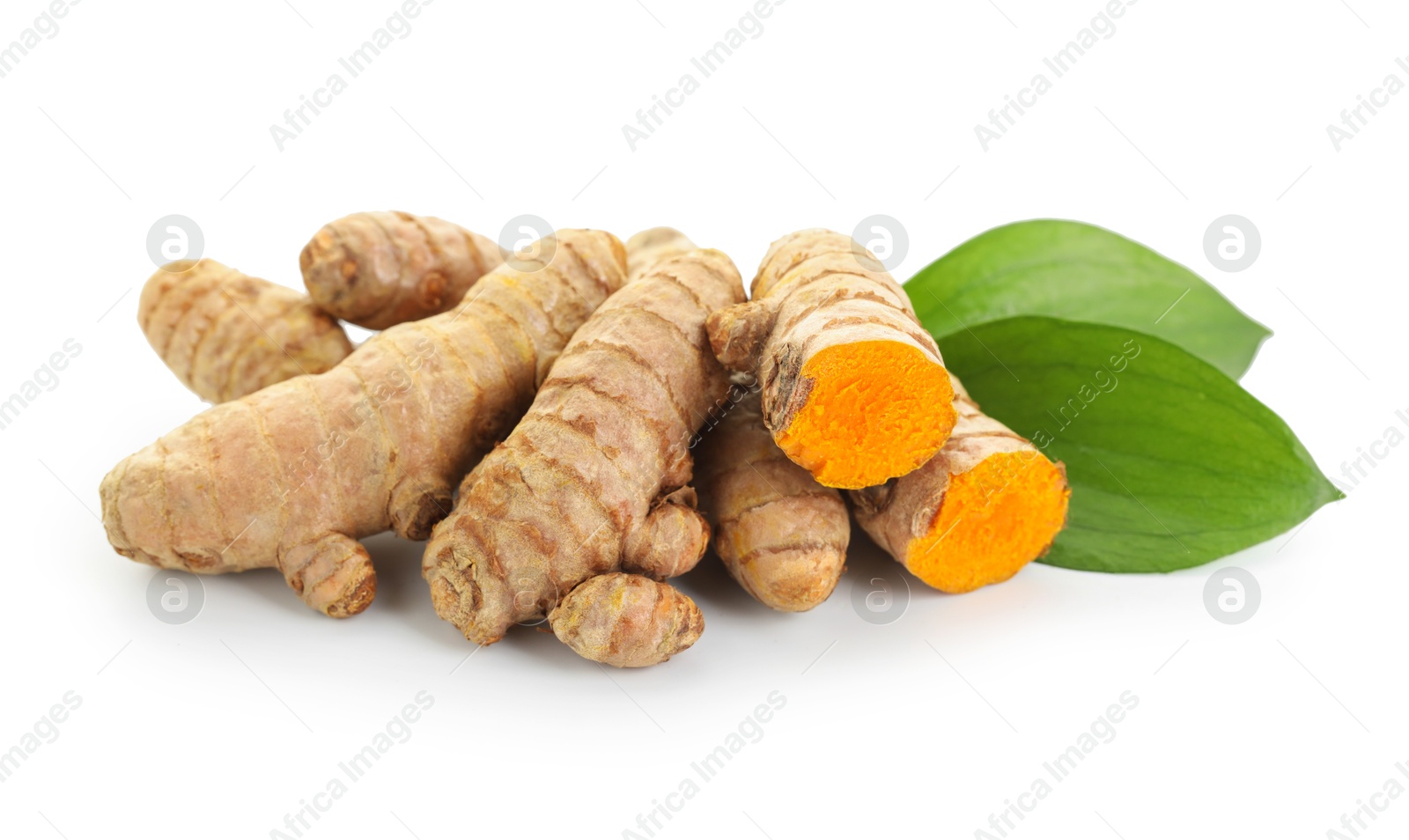 Photo of Raw turmeric roots and green leaves isolated on white