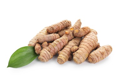 Photo of Raw turmeric roots and green leaf isolated on white