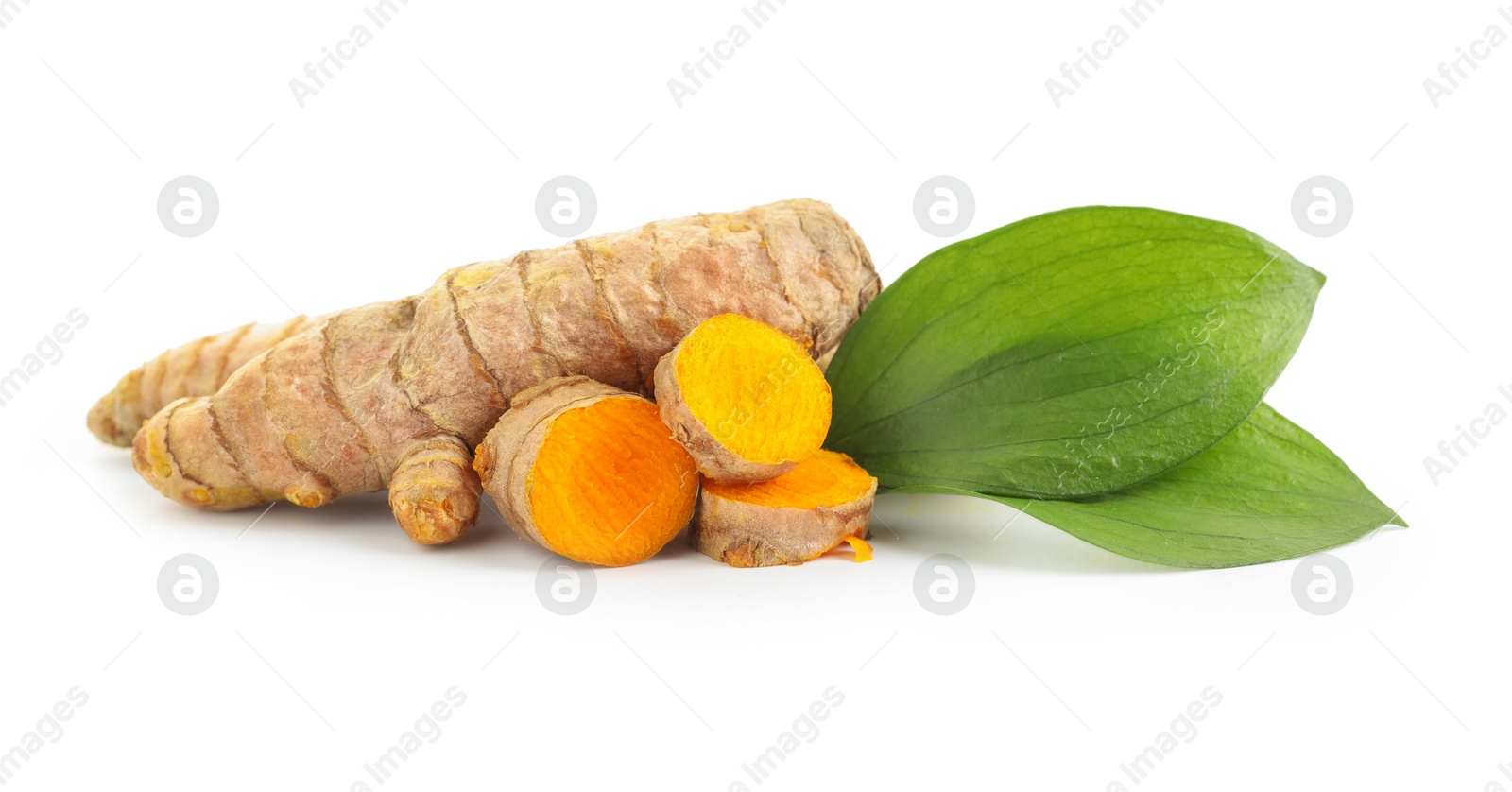 Photo of Tumeric rhizomes with leaves isolated on white