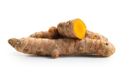 Photo of Pieces of tumeric rhizomes isolated on white