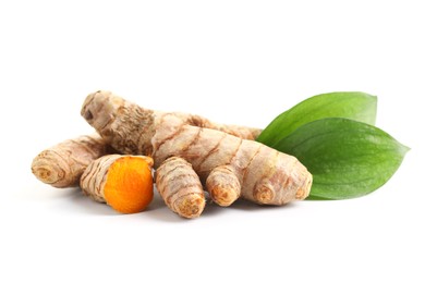 Photo of Tumeric rhizomes with leaves isolated on white