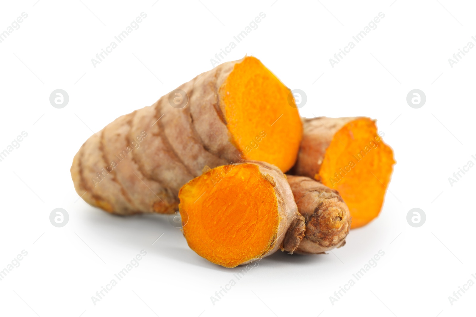 Photo of Pieces of tumeric rhizomes isolated on white