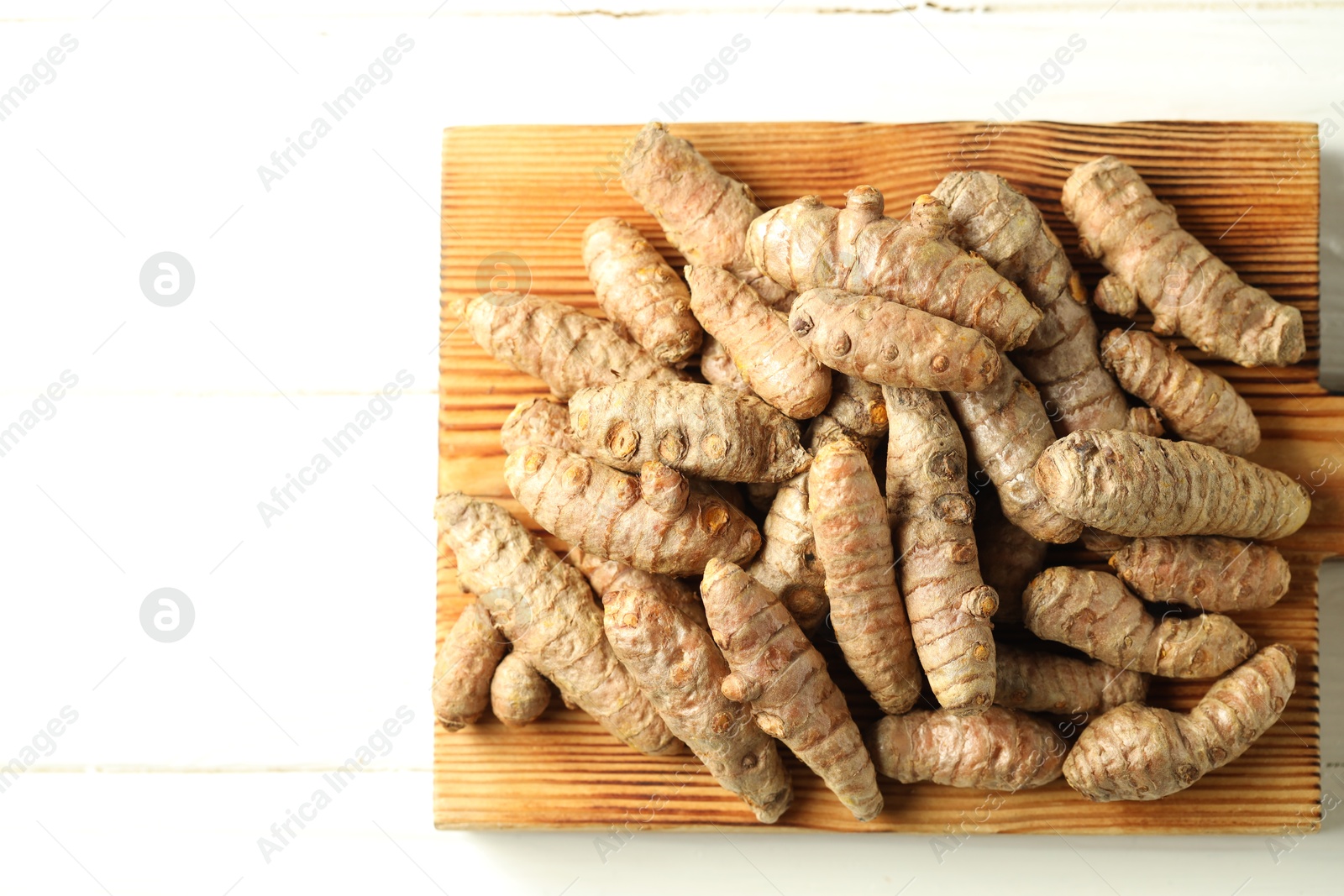 Photo of Tumeric rhizomes on white table, top view