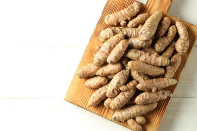 Photo of Tumeric rhizomes on white table, top view