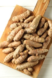 Photo of Tumeric rhizomes on white table, top view