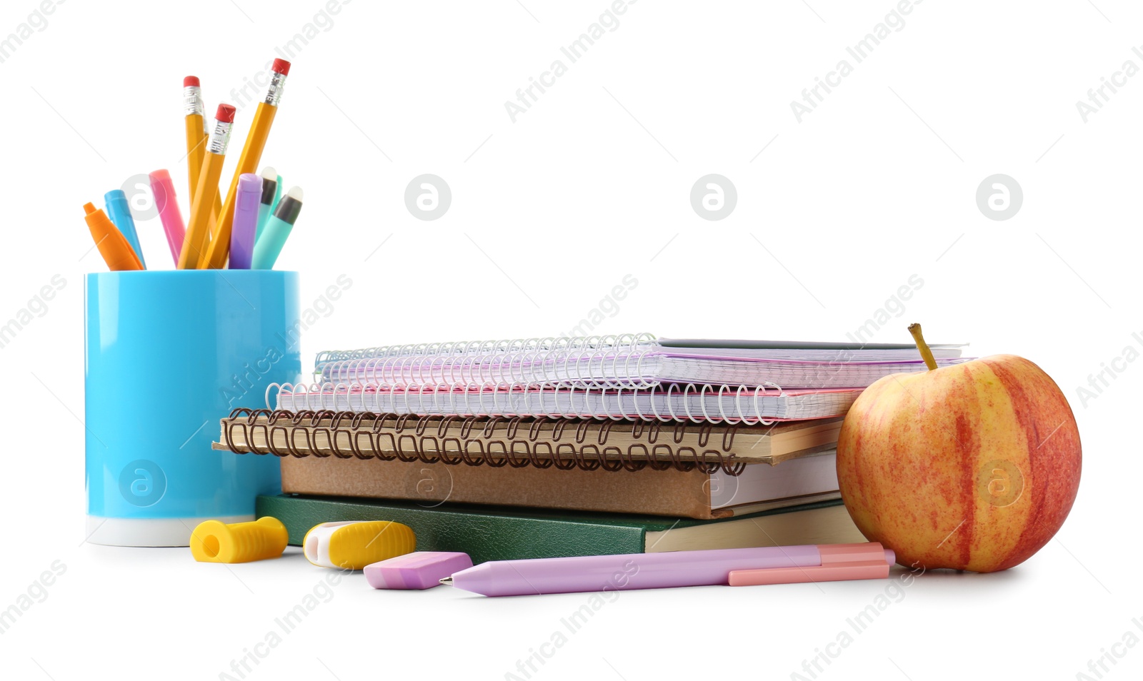 Photo of Doing homework. Notebooks, apple and stationery on white background