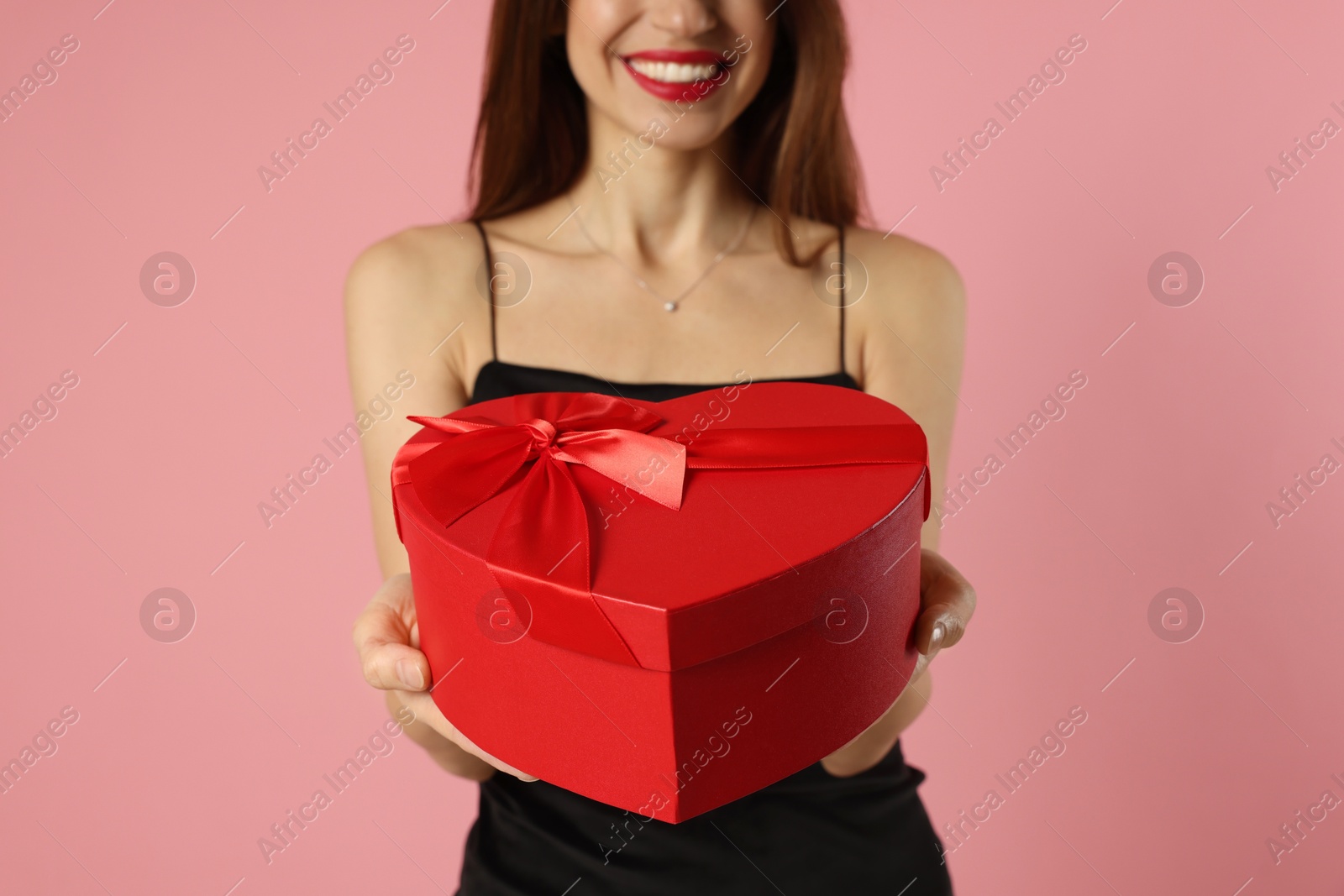 Photo of Happy Valentine's Day. Woman with heart shaped gift box on pink background, closeup