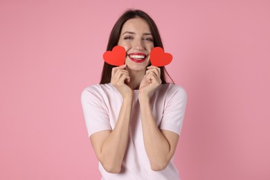 Photo of Happy Valentine's Day. Beautiful woman with paper hearts on pink background