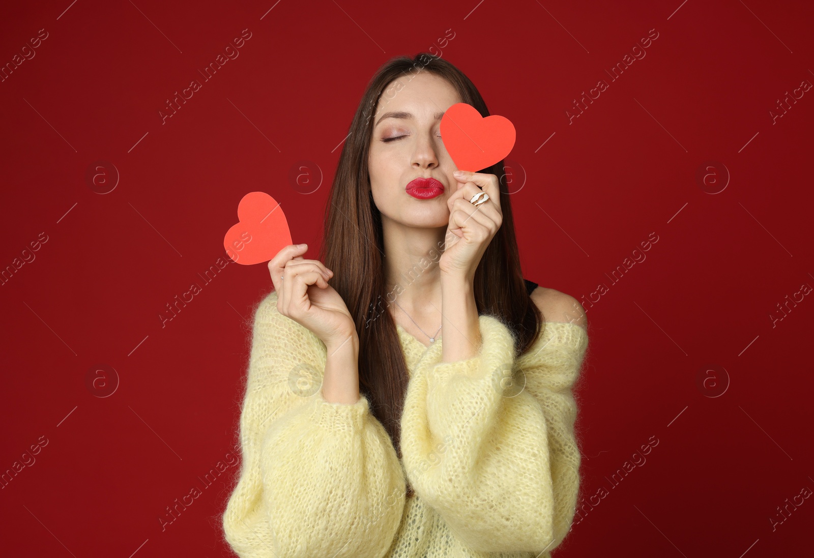 Photo of Happy Valentine's Day. Beautiful woman with paper hearts on red background