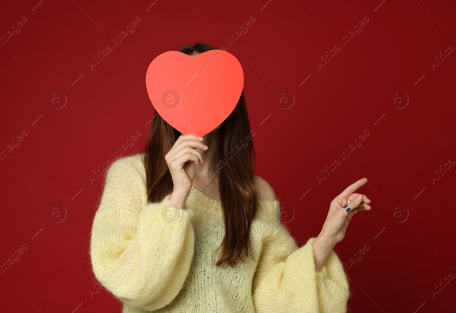 Photo of Happy Valentine's Day. Woman with paper heart on red background