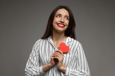 Photo of Happy Valentine's Day. Beautiful woman with paper heart on grey background