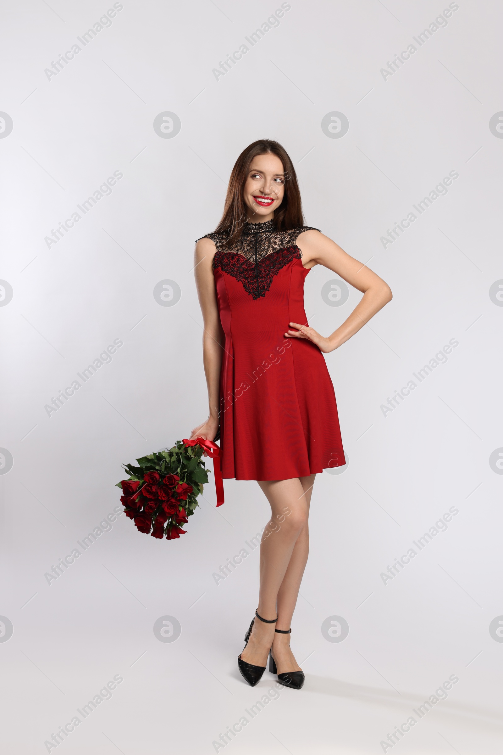 Photo of Happy Valentine's Day. Beautiful woman with bouquet of roses on white background