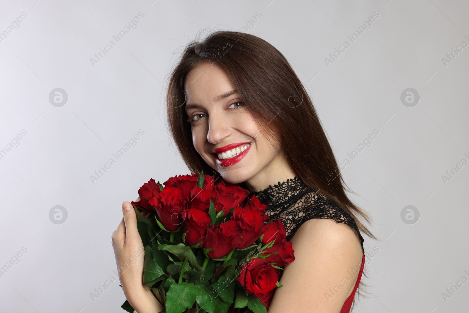 Photo of Happy Valentine's Day. Beautiful woman with bouquet of roses on white background