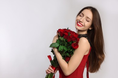 Photo of Happy Valentine's Day. Beautiful woman with bouquet of roses on white background. Space for text