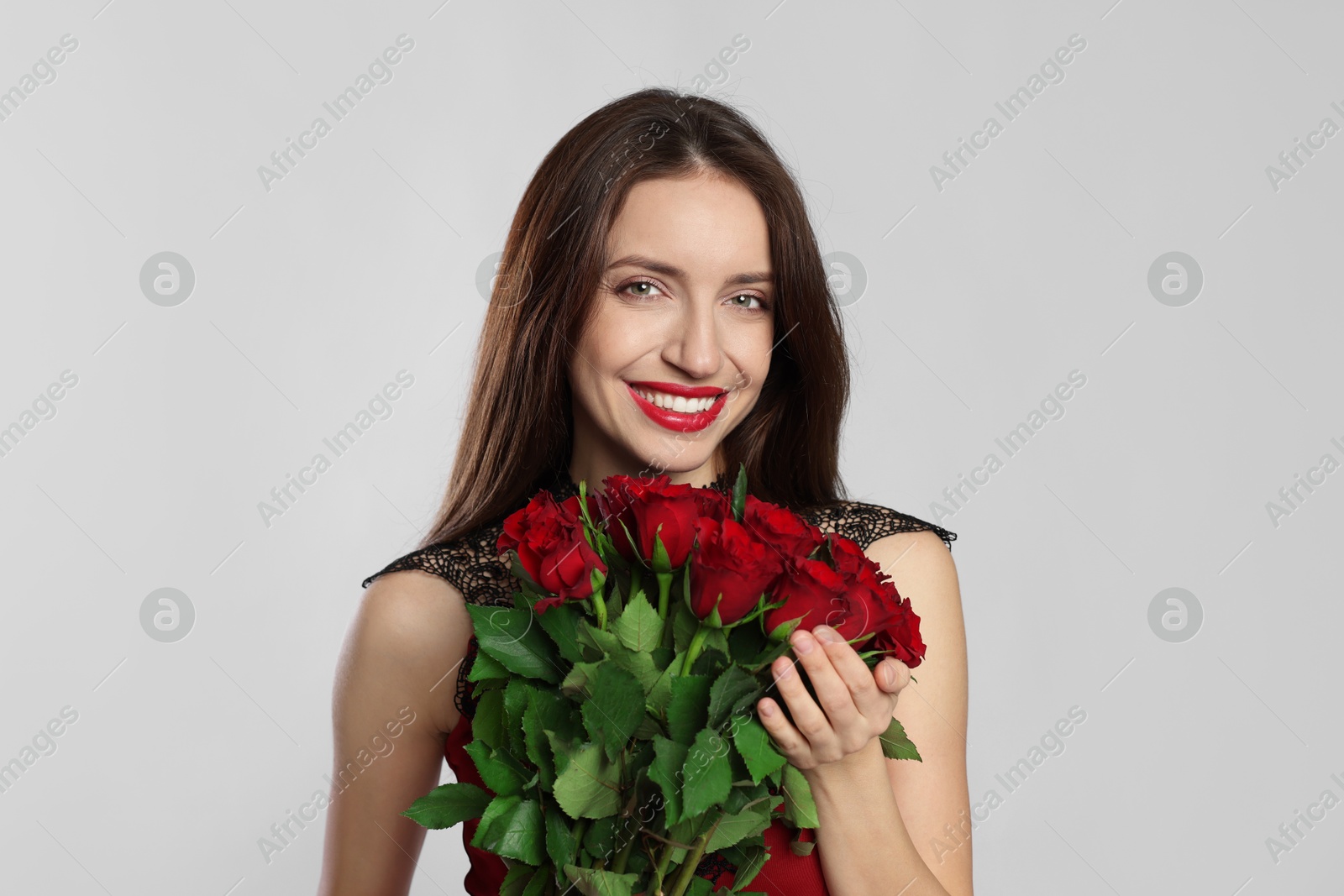 Photo of Happy Valentine's Day. Beautiful woman with bouquet of roses on white background