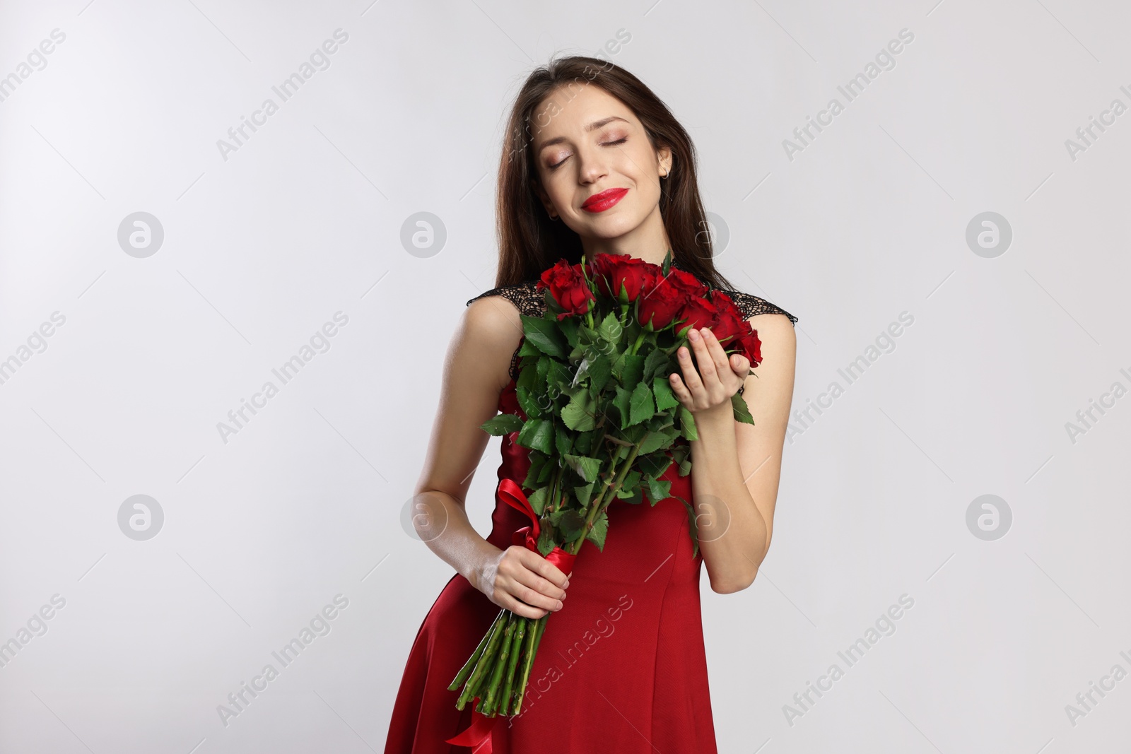 Photo of Happy Valentine's Day. Beautiful woman with bouquet of roses on white background