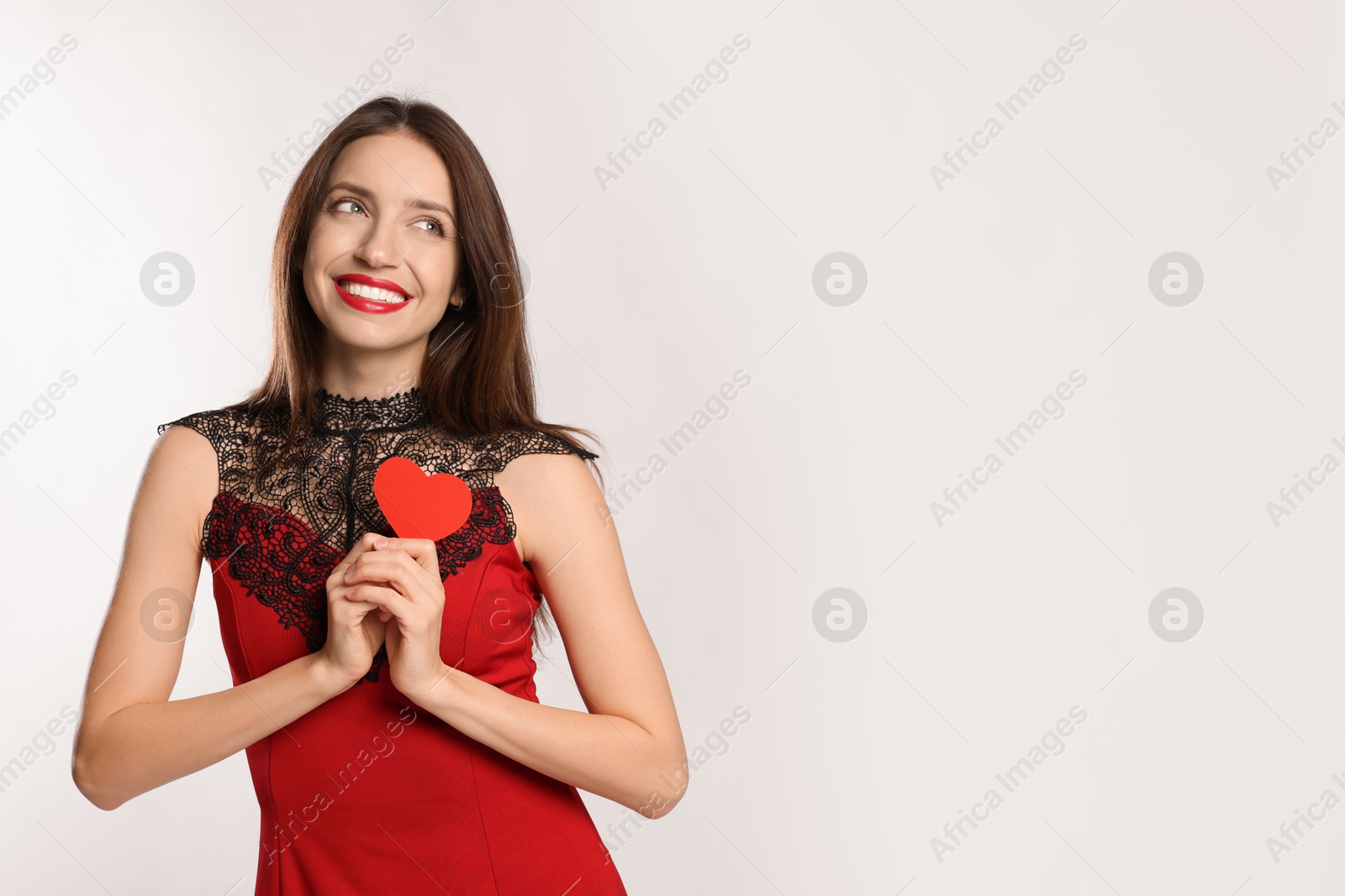 Photo of Happy Valentine's Day. Beautiful woman with paper heart on white background. Space for text