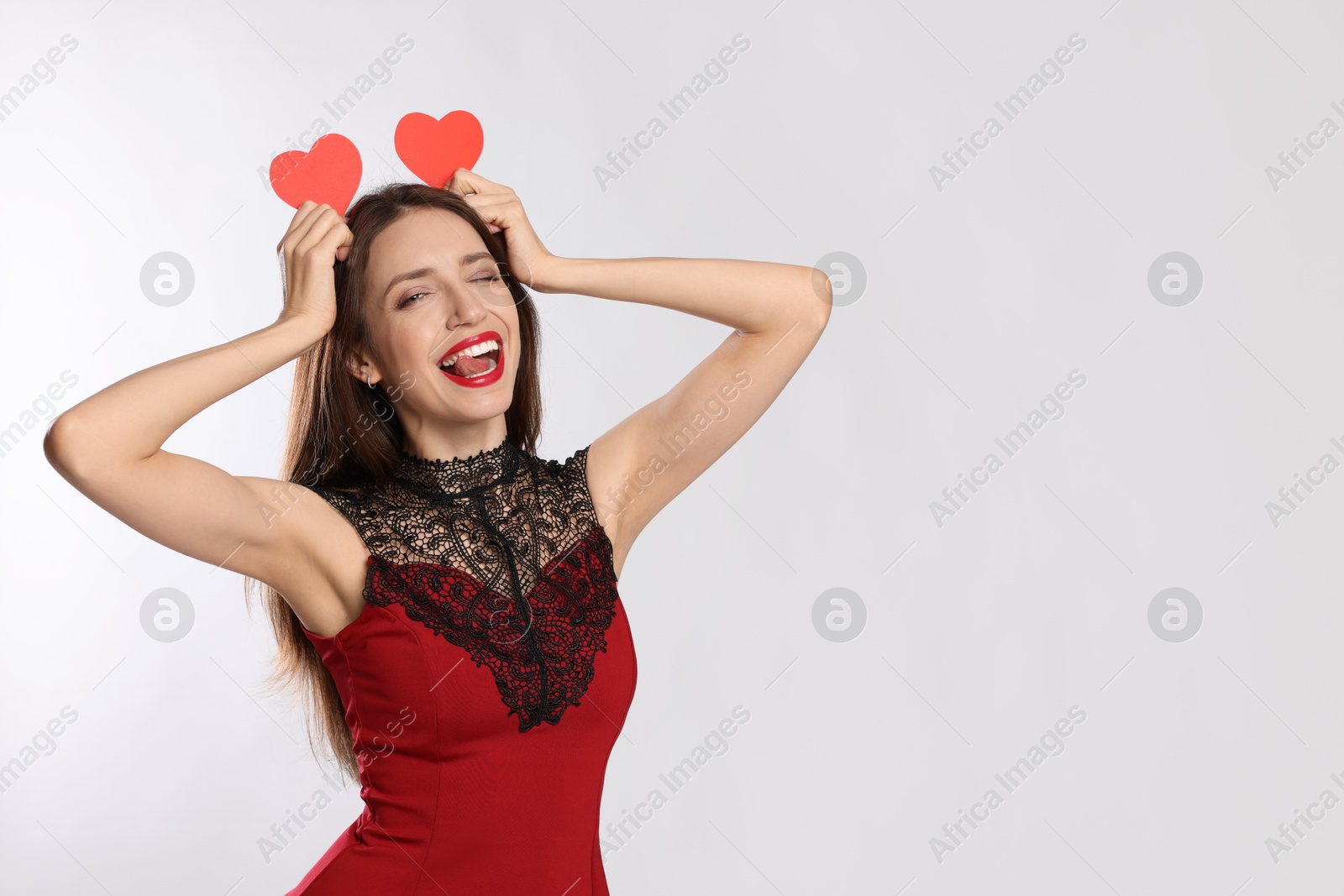 Photo of Happy Valentine's Day. Beautiful woman with paper hearts on white background. Space for text