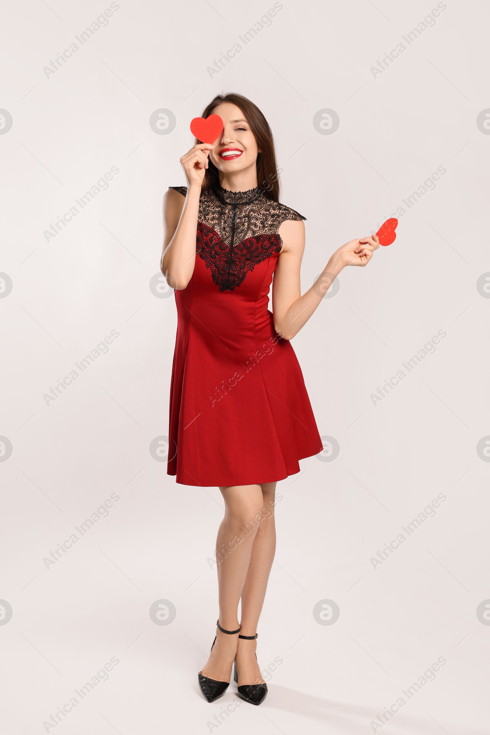 Photo of Happy Valentine's Day. Beautiful woman with paper hearts on white background