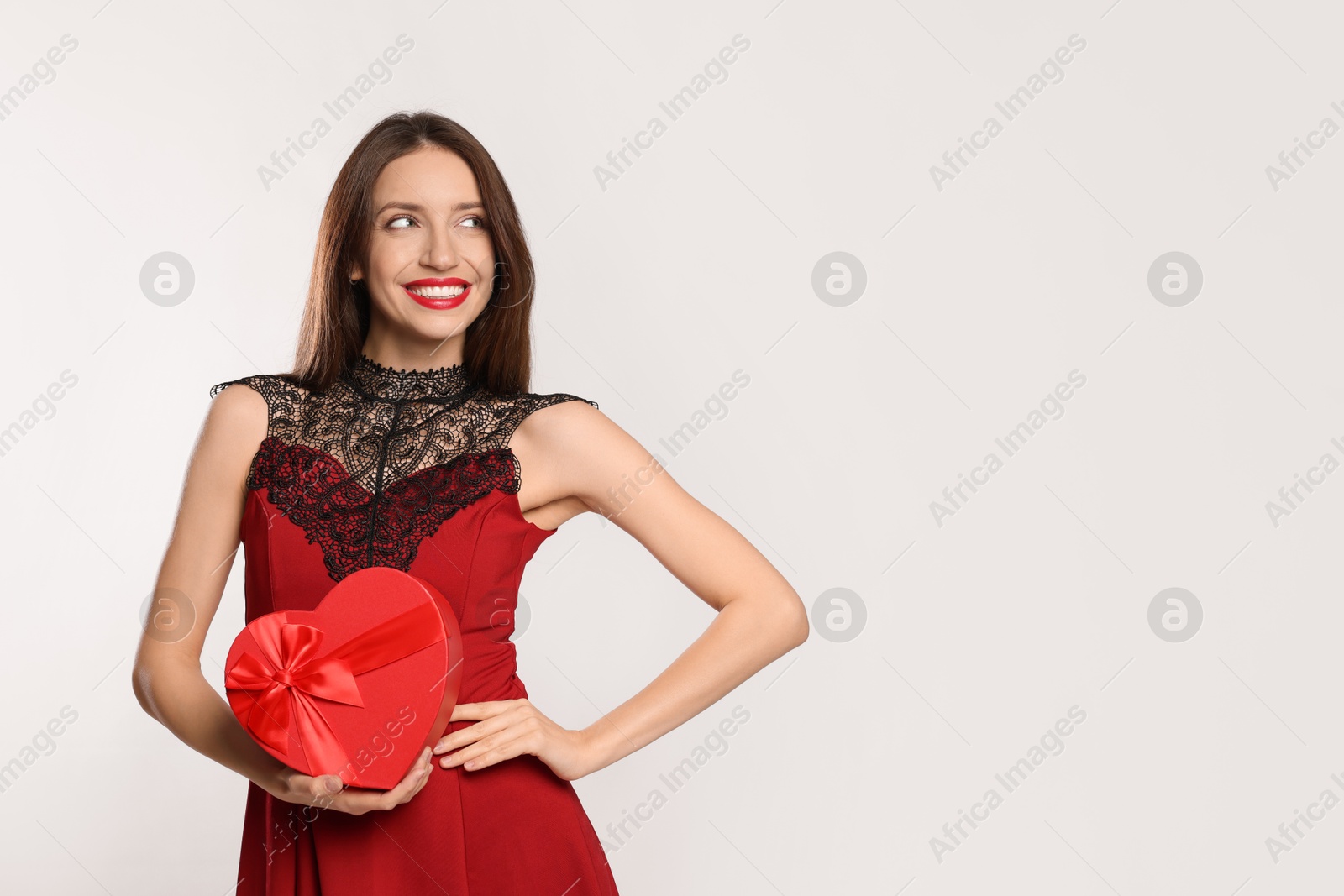 Photo of Happy Valentine's Day. Beautiful woman with heart shaped gift box on white background. Space for text