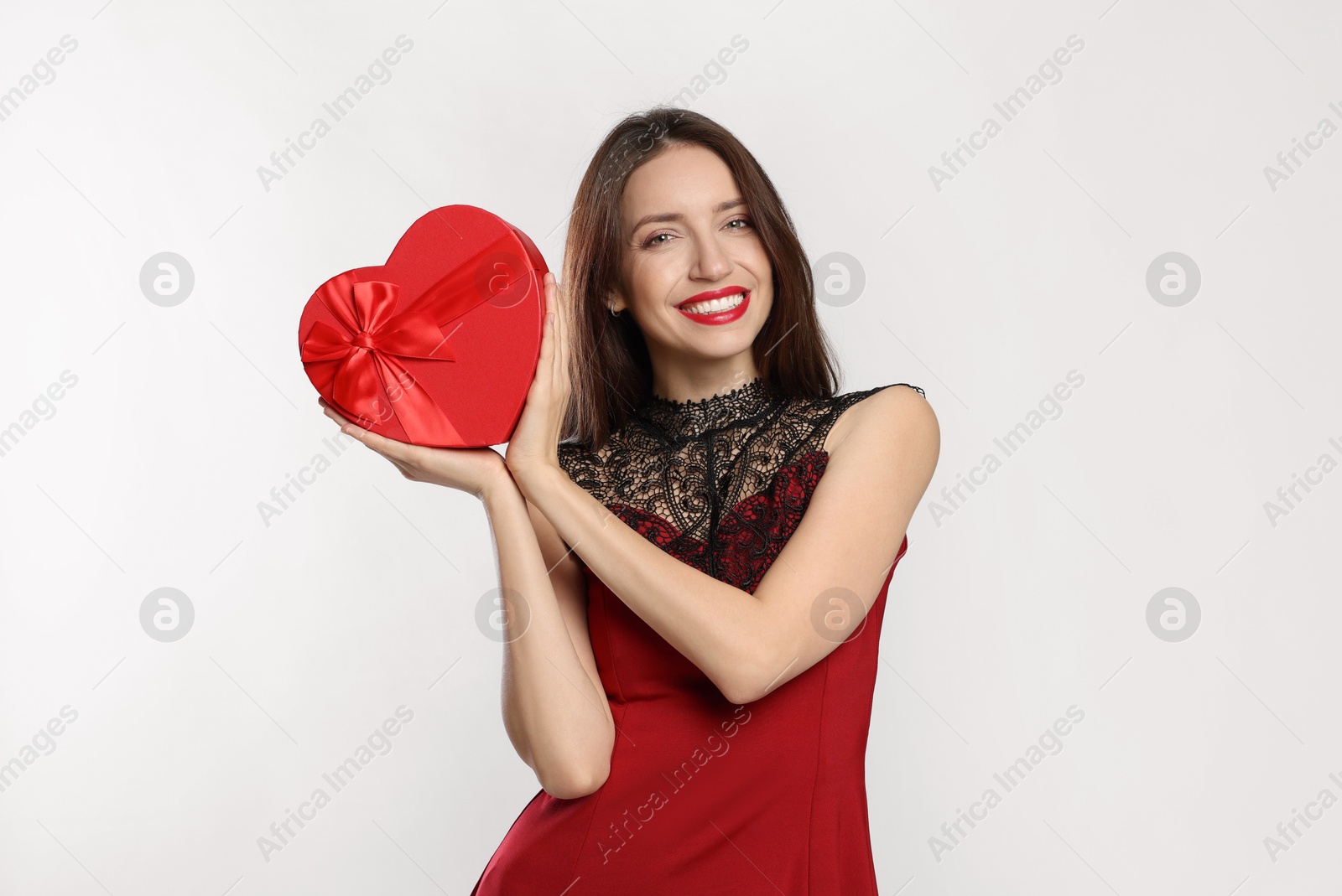 Photo of Happy Valentine's Day. Beautiful woman with heart shaped gift box on white background