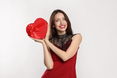 Photo of Happy Valentine's Day. Beautiful woman with heart shaped gift box on white background