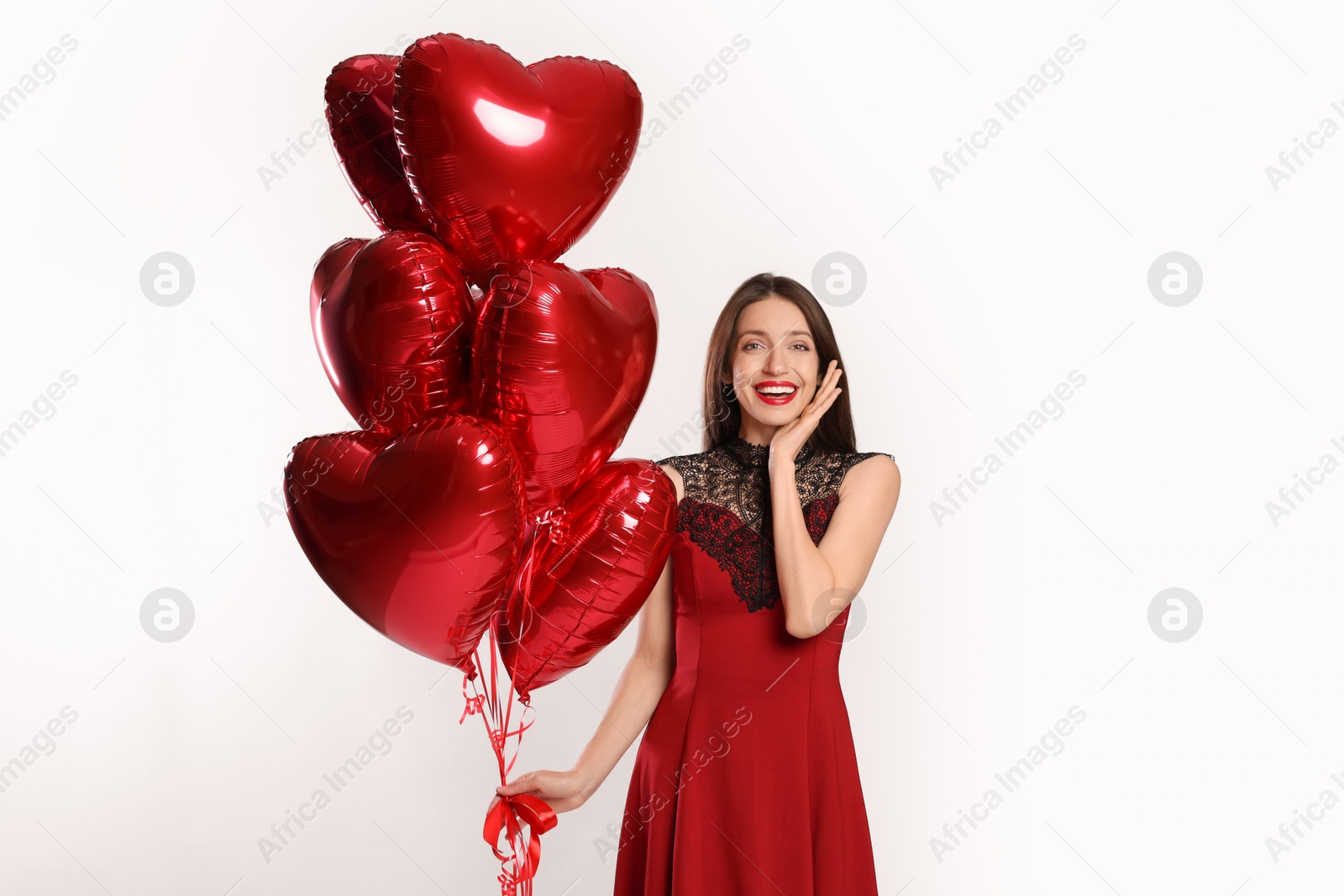 Photo of Happy Valentine's Day. Beautiful woman with heart shaped balloons on white background