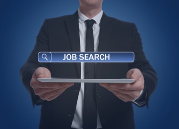 Job search. Businessman holding tablet computer on blue background, closeup. Search bar with words above device