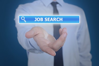 Image of Job search. Businessman holding virtual search bar on blue background, closeup