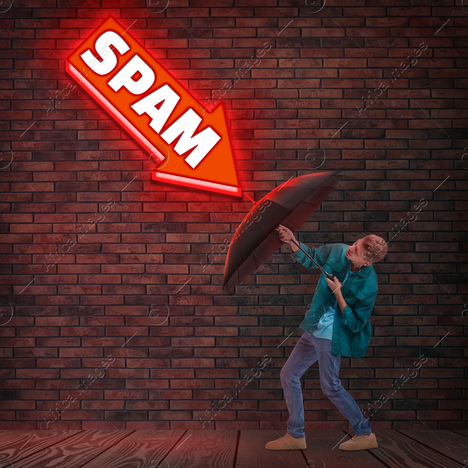 Image of Young man protecting himself from neon arrow-shaped sign Spam with umbrella. Cyber security