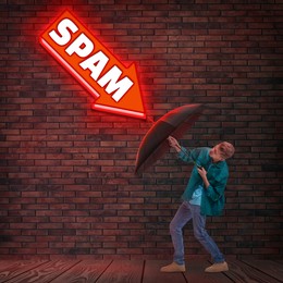 Image of Young man protecting himself from neon arrow-shaped sign Spam with umbrella. Cyber security