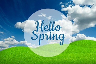 Image of Hello Spring. Vibrant green meadow under blue sky with clouds