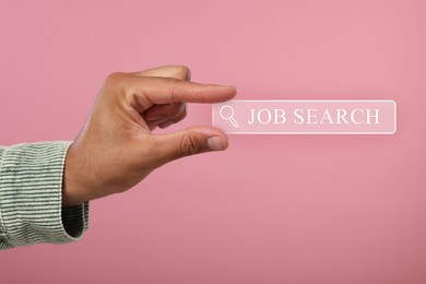 Image of Job search. Man holding virtual search bar on pink background, closeup