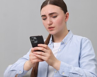 Photo of Depressed woman calling hotline for mental health help on sofa at home. Space for text