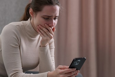 Photo of Stressed woman calling hotline for mental health help at home