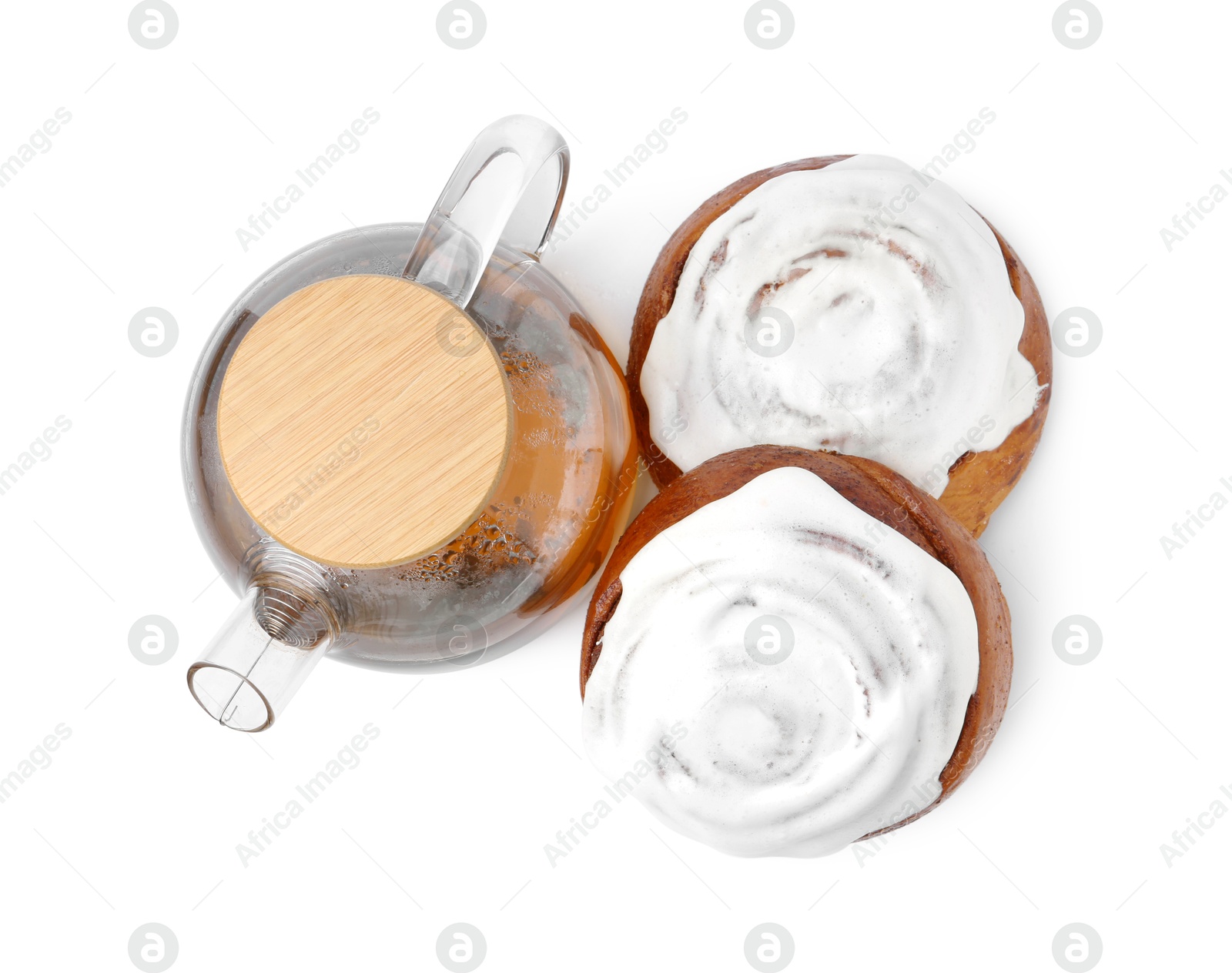 Photo of Tasty cinnamon rolls with cream and tea isolated on white, top view